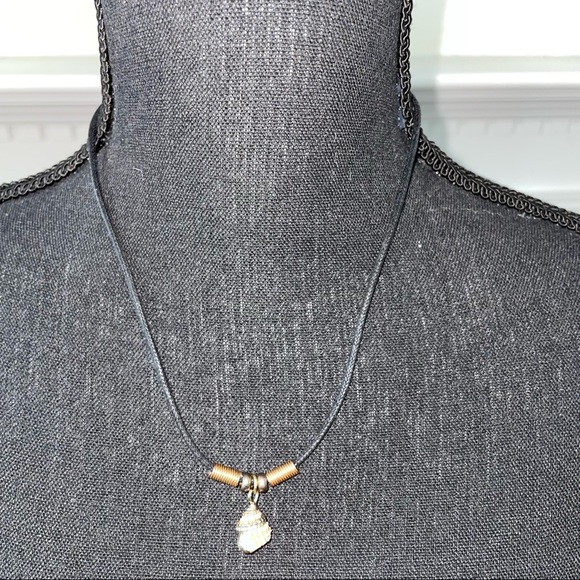 Jewelry - Black cord necklace with unique coral colored shell.